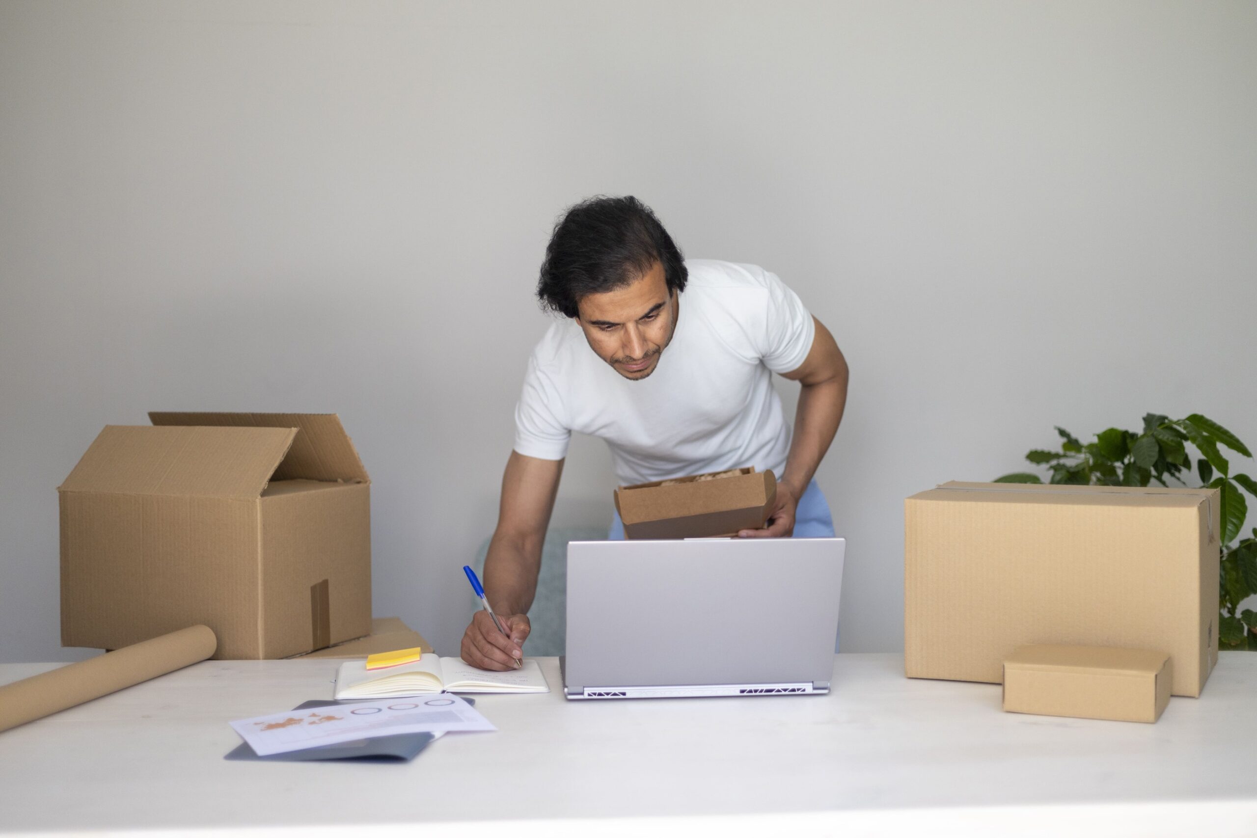 a man writing on a laptop