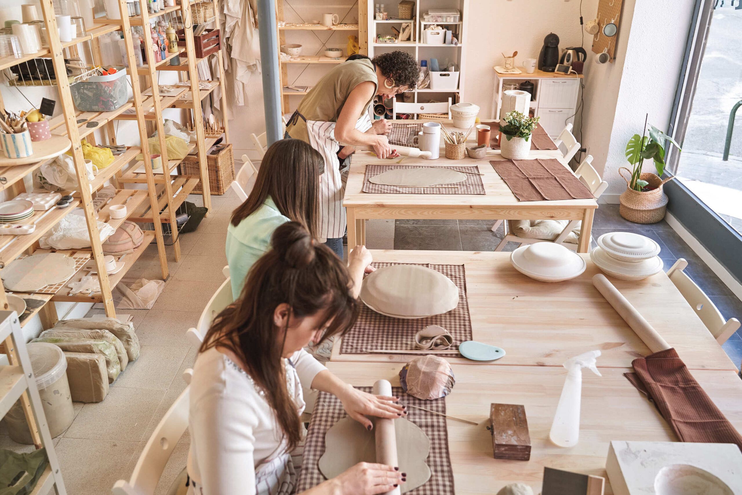 a group of women working in a pottery studio