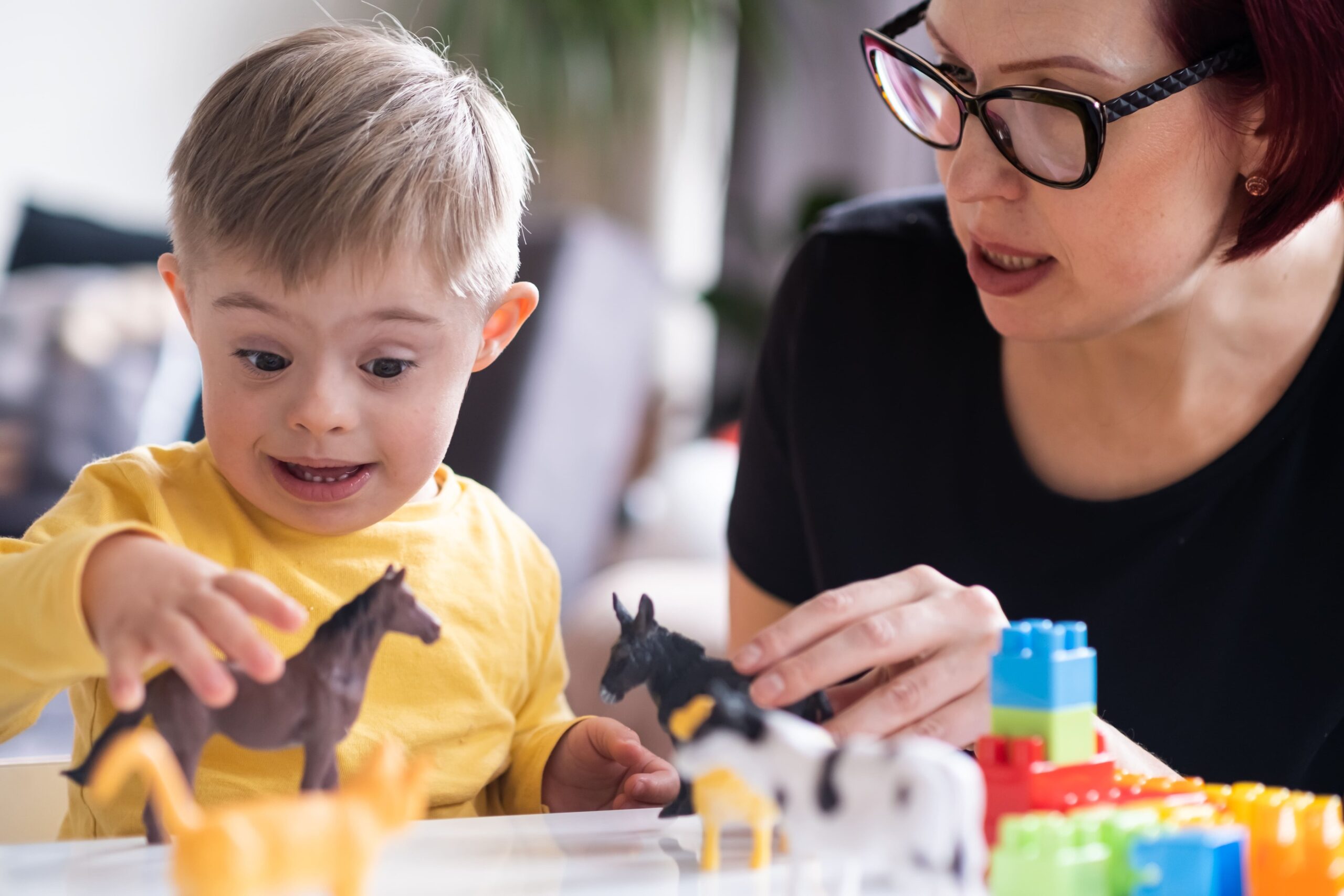 a woman and a child playing with toys