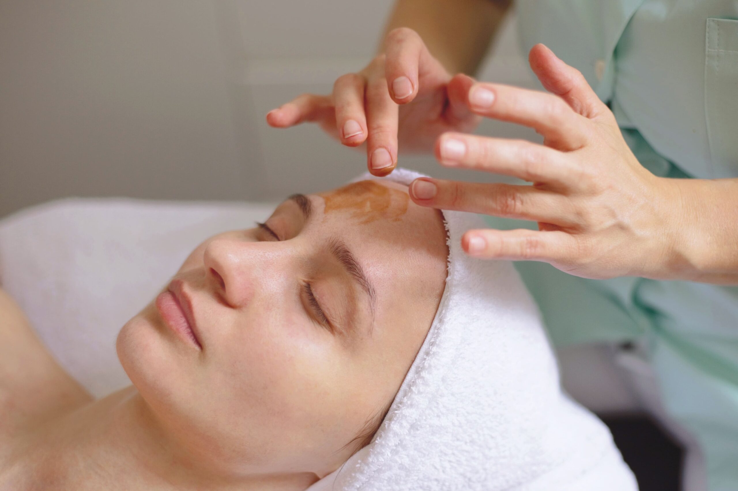 a woman getting a facial mask