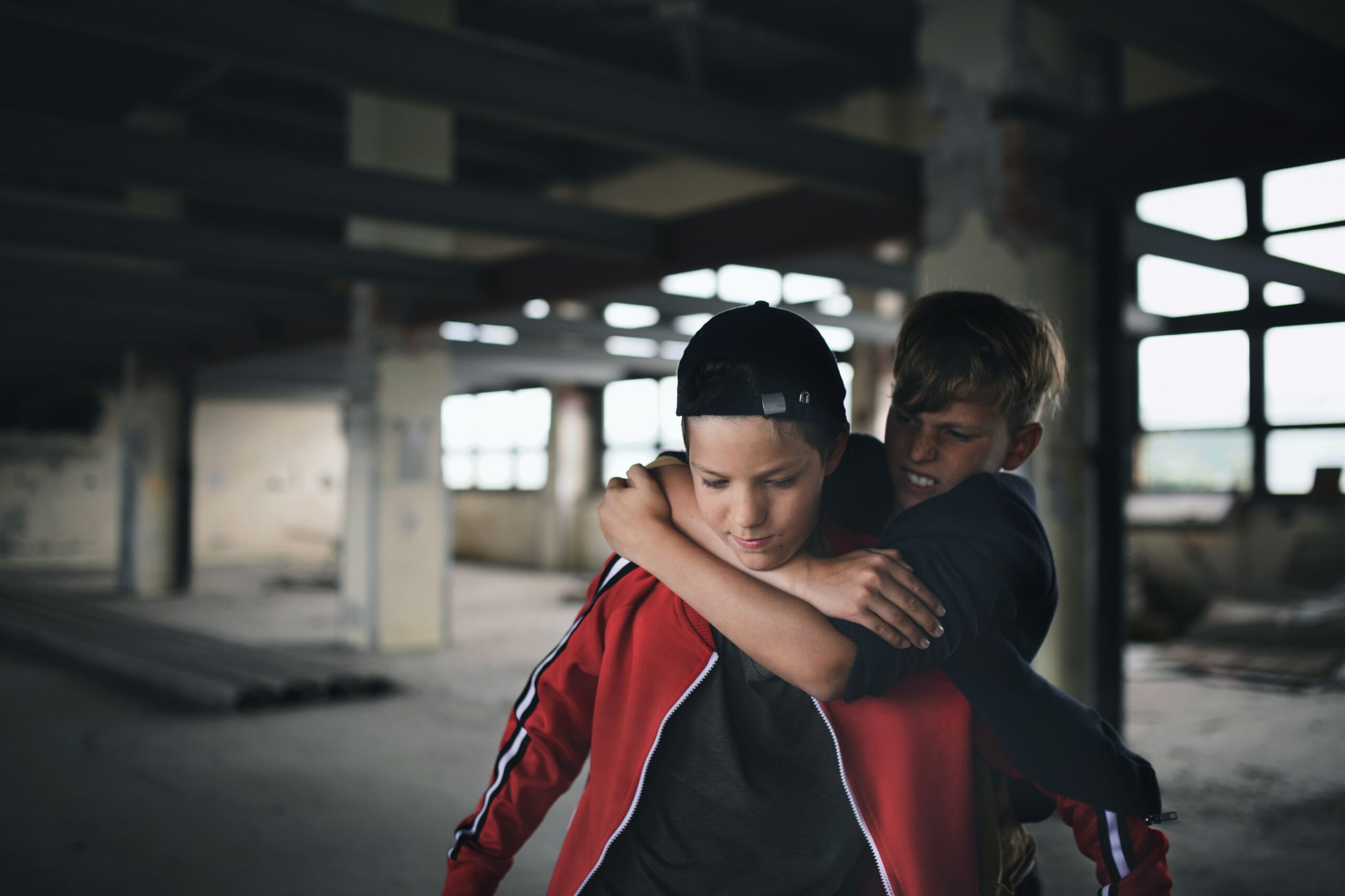 a boy hugging another boy